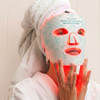 Relaxing in a robe wearing the glowing Lumora LED mask