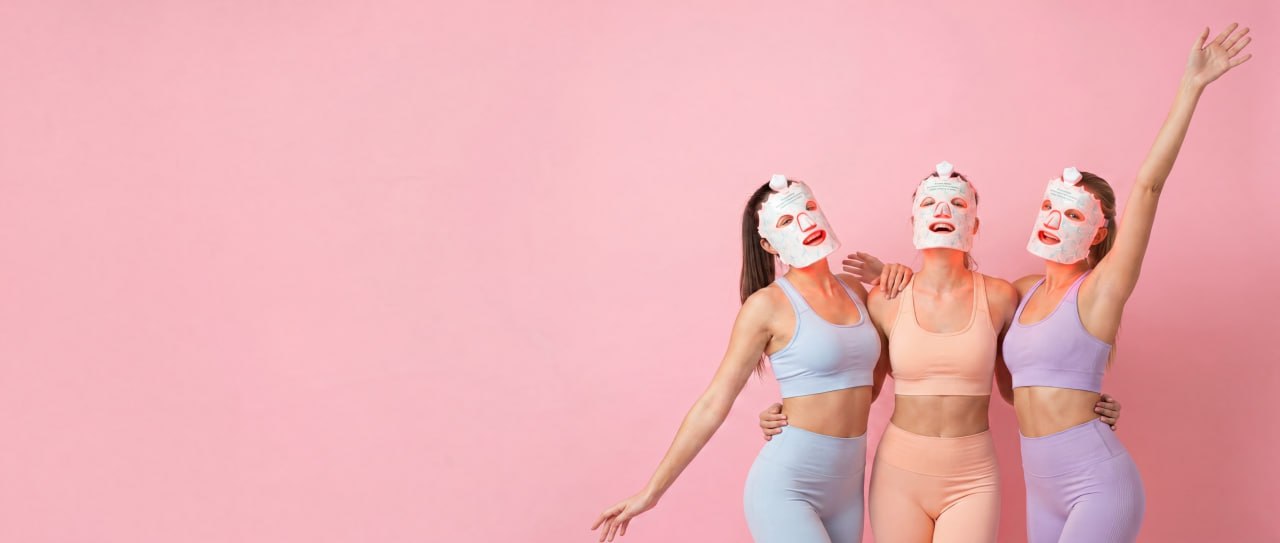 Three friends glowing together in Lumora LED light therapy masks