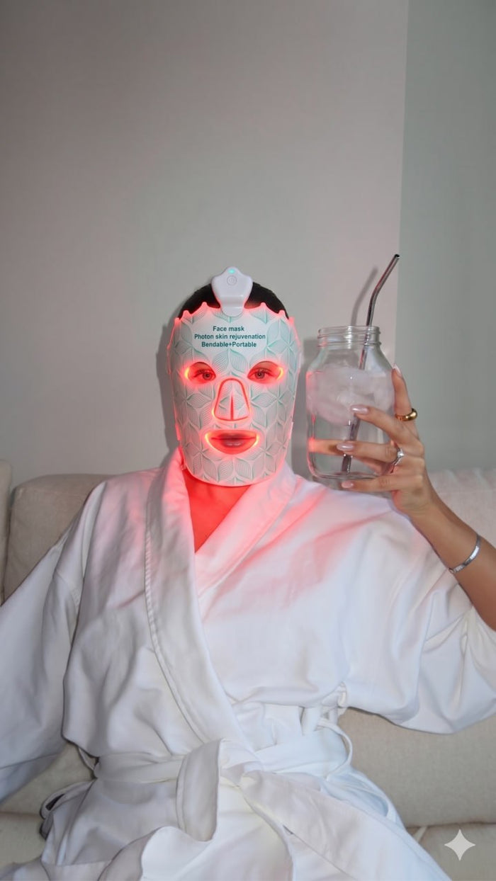 Unwinding on the couch in a robe wearing the Lumora LED mask